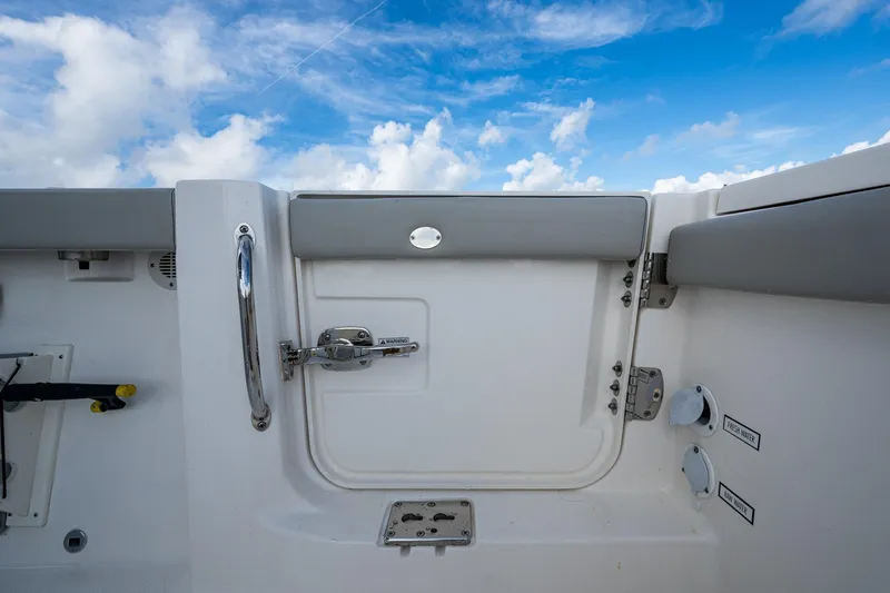 Island Girl II Yacht Photos Pics 2023 Pursuit S 358 Sport boat interior with sky view, featuring a door and handle.