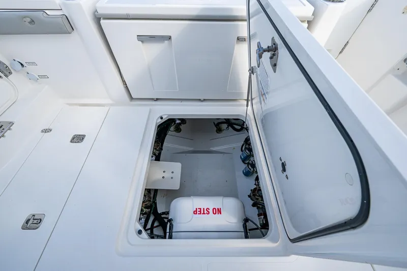 Island Girl II Yacht Photos Pics 2023 Pursuit S 358 Sport boat storage compartment with open hatch.