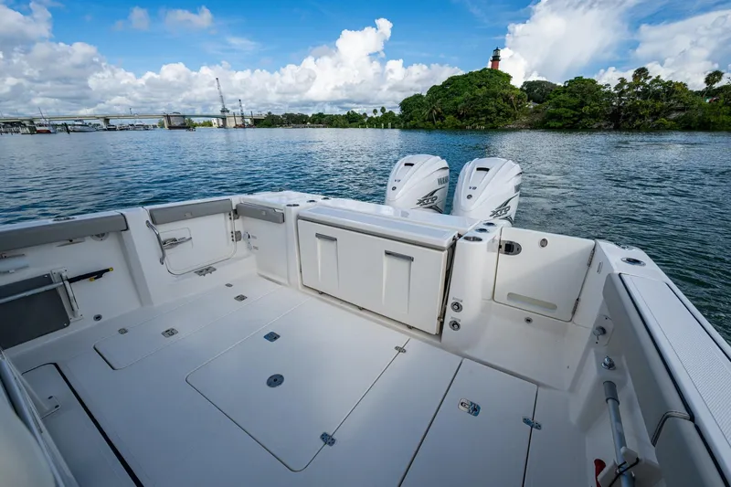 Island Girl II Yacht Photos Pics 2023 Pursuit S 358 Sport boat with dual engines on a scenic waterway.