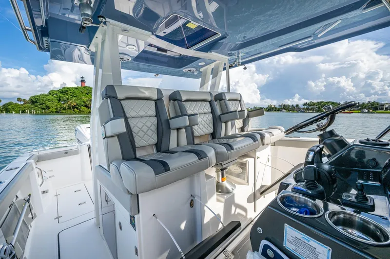 Island Girl II Yacht Photos Pics 2023 Pursuit S 358 Sport boat interior with luxurious seating and modern helm.