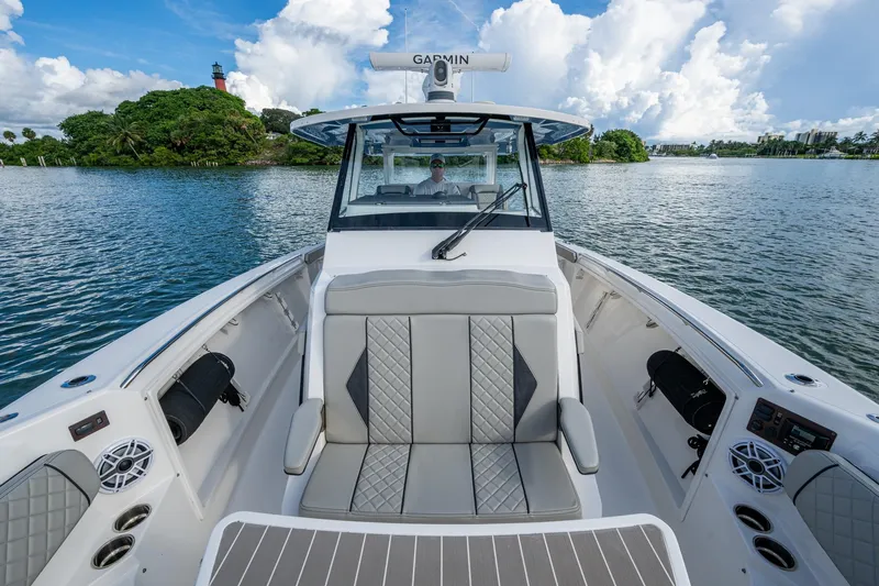 Island Girl II Yacht Photos Pics 2023 Pursuit S 358 Sport boat interior with luxurious seating on a scenic waterway.