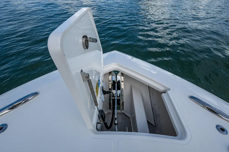 Island Girl II Yacht Photos Pics 2023 Pursuit S 358 Sport boat anchor compartment open on water.