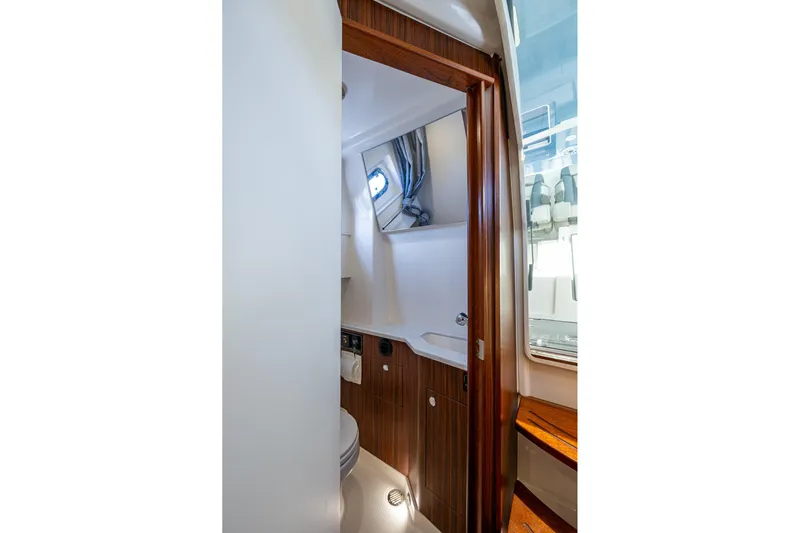 Island Girl II Yacht Photos Pics 2023 Pursuit S 358 Sport boat interior bathroom with wood accents and modern fixtures.