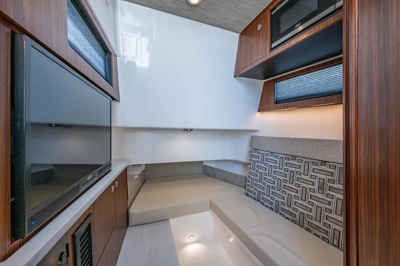 Island Girl II Yacht Photos Pics 2023 Pursuit S 358 Sport cabin interior with modern design and wood accents.