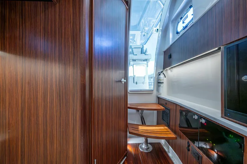 Island Girl II Yacht Photos Pics 2023 Pursuit S 358 Sport interior with wood finish and modern amenities.