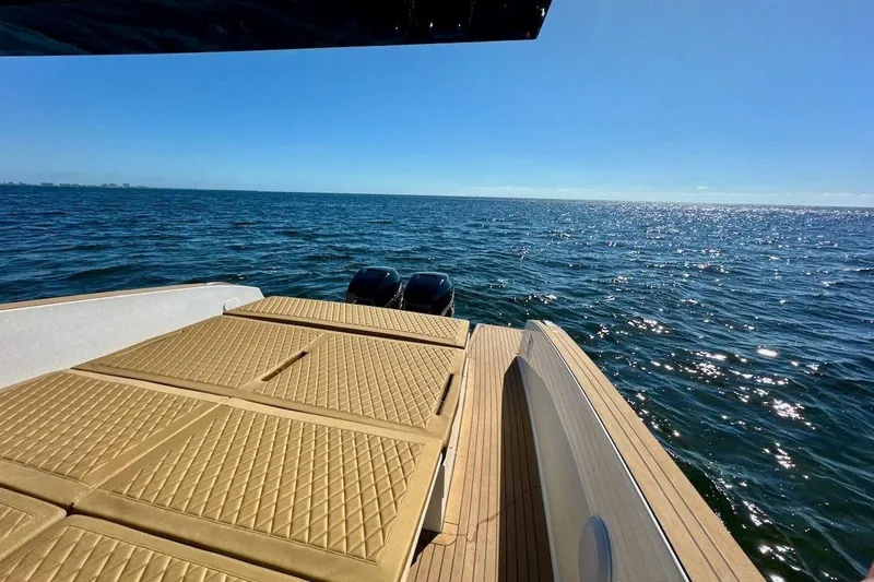  Yacht Photos Pics 2023 Tesoro T38 yacht with sun deck, overlooking sparkling ocean waters.