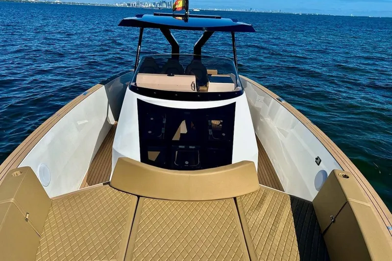  Yacht Photos Pics 2023 Tesoro T38 luxury boat on open water, featuring sleek design and spacious deck.