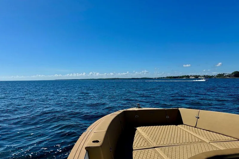  Yacht Photos Pics 2023 Tesoro T38 boat on open sea under clear blue sky.