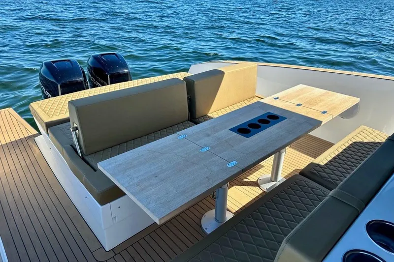  Yacht Photos Pics Luxury Tesoro T38 boat interior with seating and table, 2023 model, on open water.