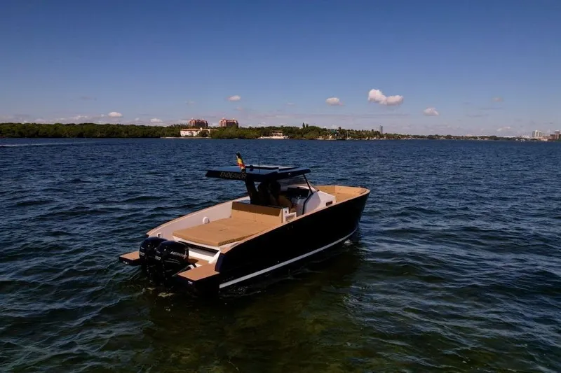  Yacht Photos Pics 2023 Tesoro T38 boat on calm waters under clear blue sky.