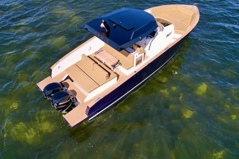 Yacht Photos Pics 2023 Tesoro T38 luxury boat on clear water, featuring sleek design and dual engines.