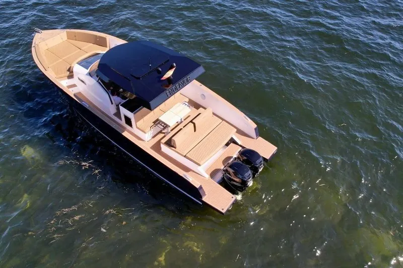  Yacht Photos Pics 2023 Tesoro T38 boat cruising on open water, featuring sleek design and dual engines.