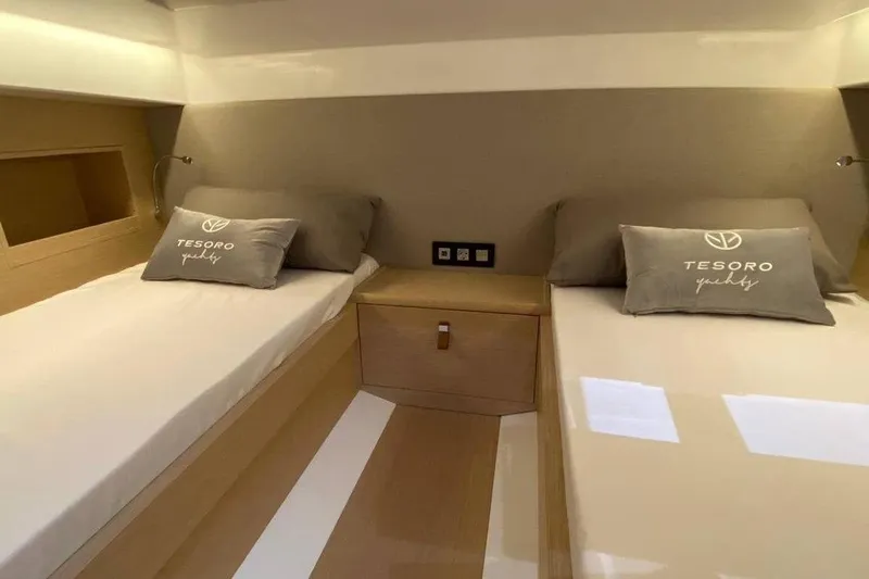  Yacht Photos Pics 2023 Tesoro T38 yacht cabin with twin beds and branded pillows.