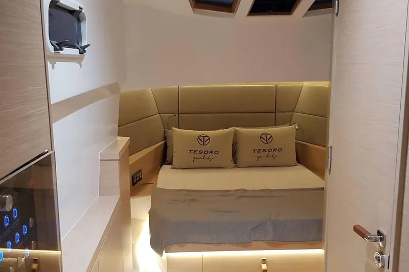  Yacht Photos Pics Luxurious interior of 2023 Tesoro T38 yacht cabin with elegant bedding and ambient lighting.