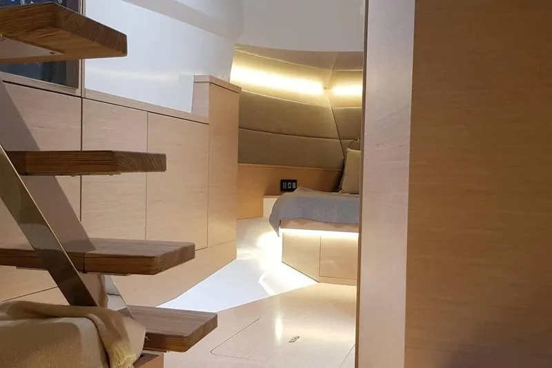  Yacht Photos Pics Luxurious interior of 2023 Tesoro T38 yacht with modern wooden design and ambient lighting.