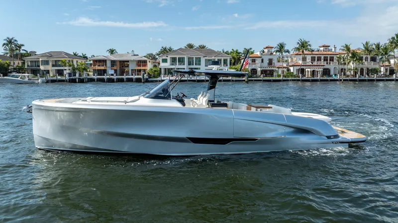  Yacht Photos Pics 2025 Solaris Power 44 Open yacht cruising near waterfront homes.