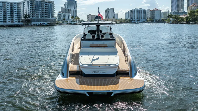  Yacht Photos Pics 2025 Solaris Power 44 Open yacht on water, city skyline in background.