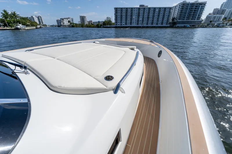  Yacht Photos Pics 2025 Solaris Power 44 Open yacht on water, showcasing sleek deck design and urban skyline backdrop.