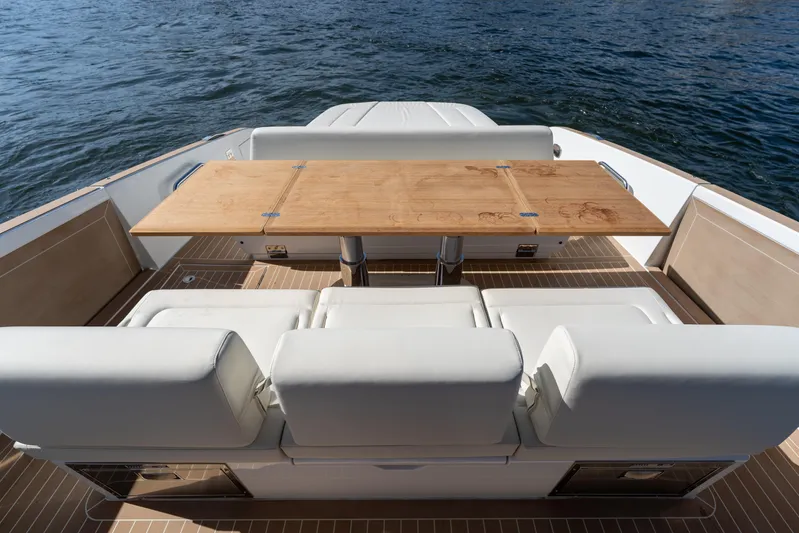  Yacht Photos Pics Luxurious seating area on Solaris Power 44 Open yacht, 2025 model, with elegant wooden table.