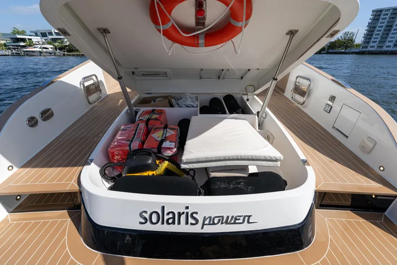  Yacht Photos Pics 2025 Solaris Power 44 Open yacht with open storage compartment, life jackets, and cushions.
