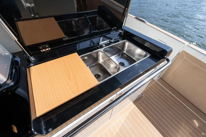  Yacht Photos Pics Outdoor kitchen on 2025 Solaris Power 44 Open yacht with dual sinks and wooden cutting board.