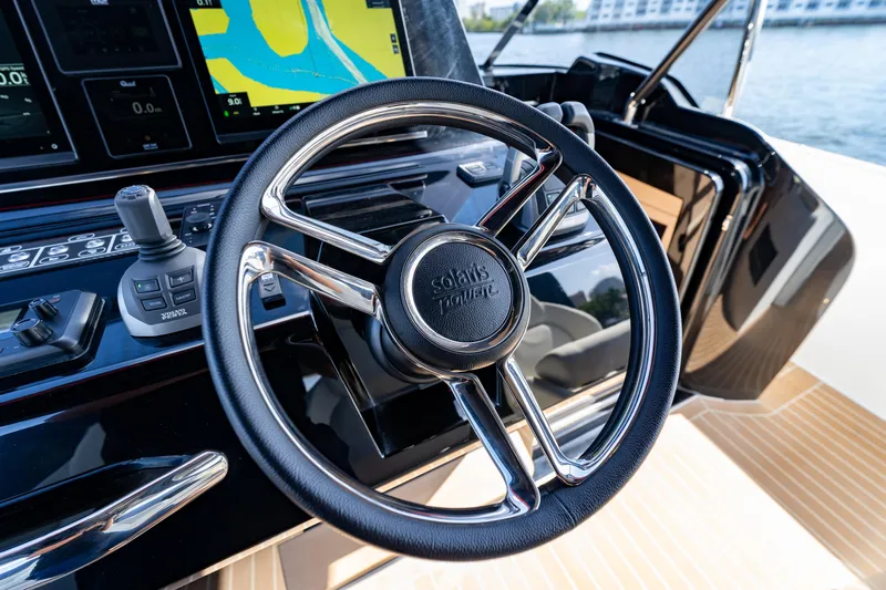 Yacht Photos Pics Steering wheel of 2025 Solaris Power 44 Open yacht with navigation display.