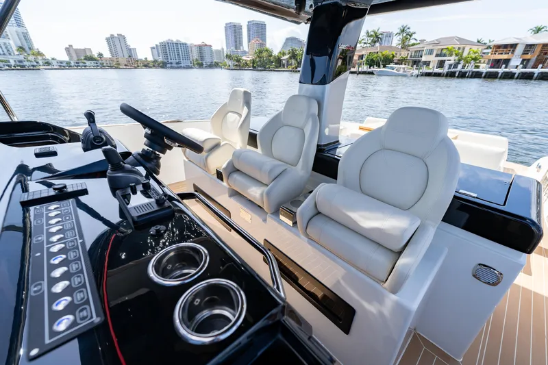  Yacht Photos Pics 2025 Solaris Power 44 Open yacht interior with luxurious seating and modern controls, docked by waterfront.