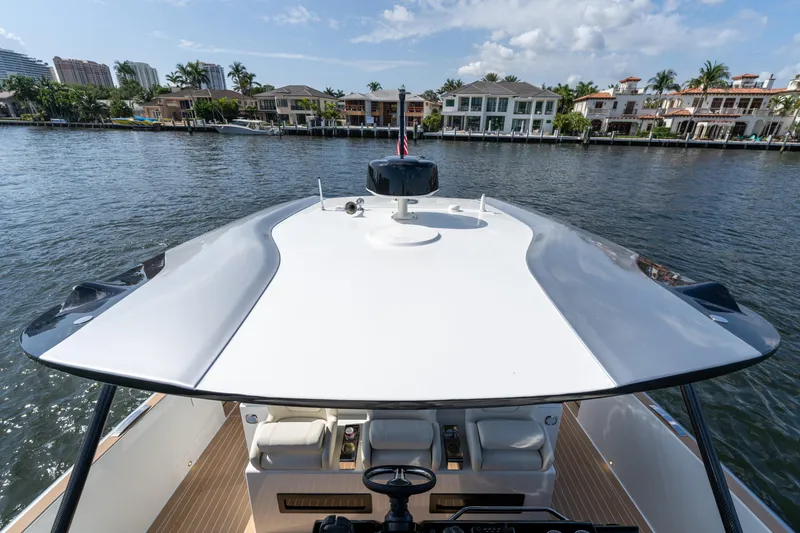  Yacht Photos Pics 2025 Solaris Power 44 Open yacht cruising on a scenic waterfront.