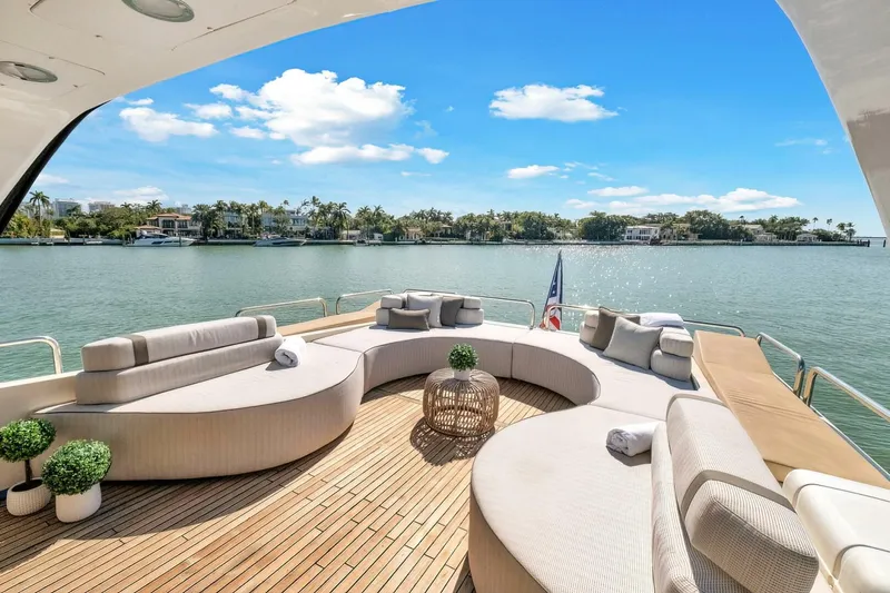 Boulos Yacht Photos Pics Luxurious Gianetti 86 yacht deck with elegant seating, scenic waterfront view, and clear blue sky.