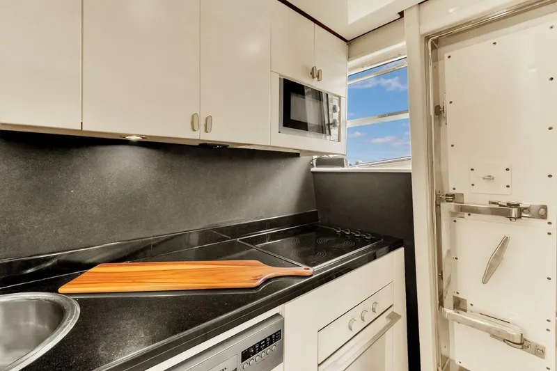 Boulos Yacht Photos Pics Compact kitchen in a 2003 Gianetti 86 yacht with modern appliances and sleek design.