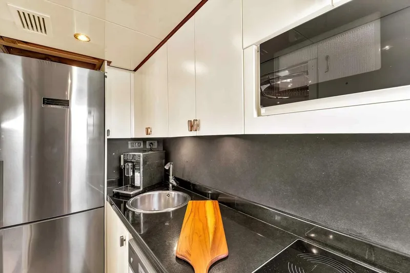 Boulos Yacht Photos Pics Modern kitchen in 2003 Gianetti 86 yacht with sleek appliances and wooden accents.