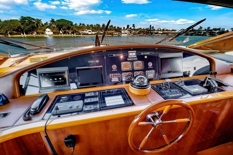 Boulos Yacht Photos Pics Helm of 2003 Gianetti 86 yacht with navigation instruments and scenic waterfront view.