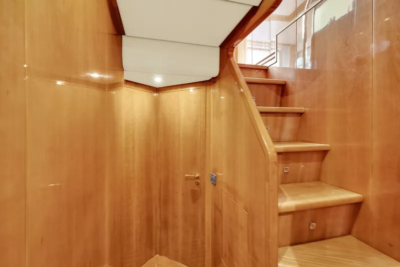 Boulos Yacht Photos Pics Wooden staircase interior of 2003 Gianetti 86 yacht, featuring polished wood finish.