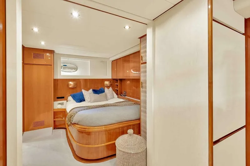 Boulos Yacht Photos Pics Luxurious bedroom interior on 2003 Gianetti 86 yacht, featuring elegant wood finishes and cozy bedding.