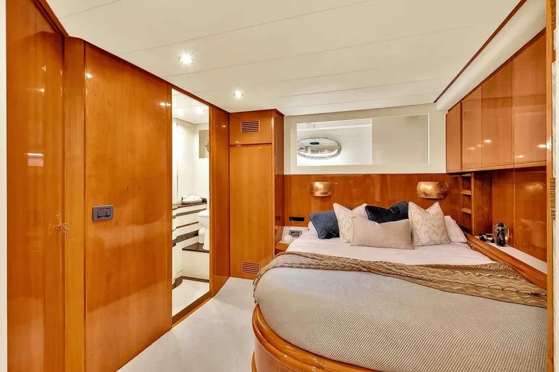 Boulos Yacht Photos Pics Luxurious cabin interior of 2003 Gianetti 86 yacht with wood paneling and cozy bedding.