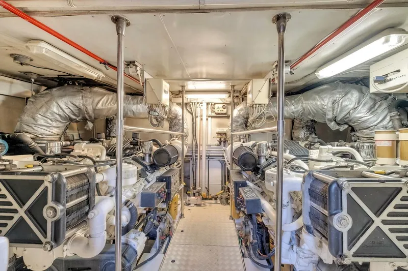 Boulos Yacht Photos Pics Engine room of 2003 Gianetti 86 yacht, featuring dual engines and complex piping system.
