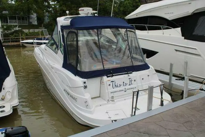  Yacht Photos Pics 2011 Four Winns V335 boat docked with blue canopy and "This is It" text on stern.