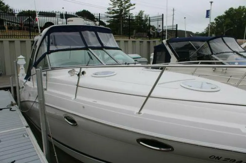  Yacht Photos Pics 2011 Four Winns V335 boat docked at marina, featuring sleek design and blue canopy.
