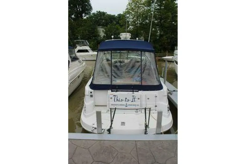  Yacht Photos Pics 2011 Four Winns V335 boat docked, rear view with blue canopy and clear windows.