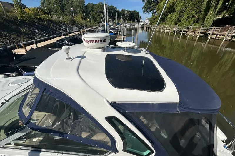  Yacht Photos Pics 2011 Four Winns V335 boat docked, featuring Raymarine equipment and sleek design.