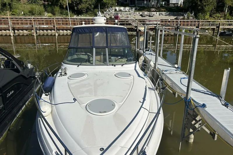  Yacht Photos Pics 2011 Four Winns V335 boat docked at a marina, surrounded by calm water.