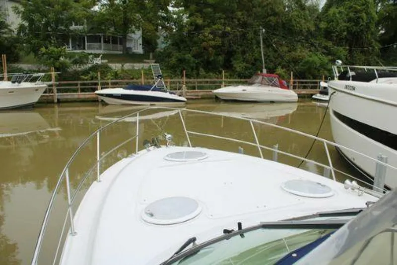  Yacht Photos Pics 2011 Four Winns V335 boat docked in a calm marina with surrounding boats.