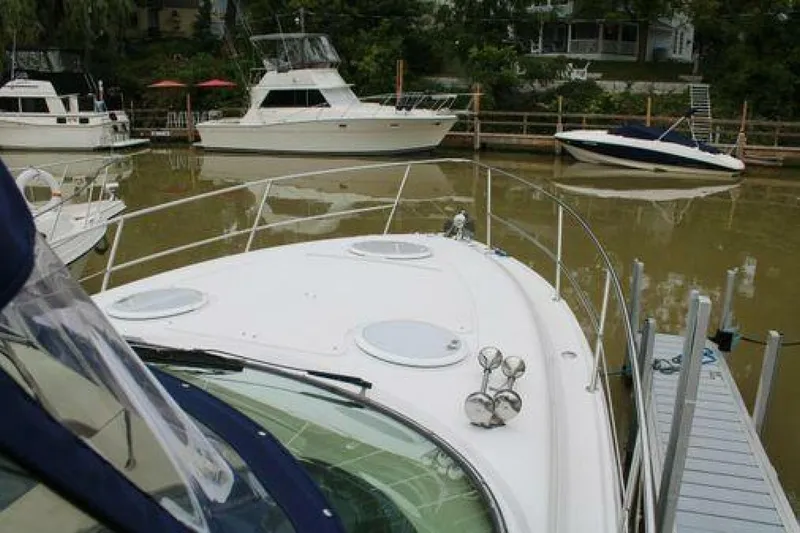  Yacht Photos Pics 2011 Four Winns V335 boat docked, surrounded by other boats in a marina.