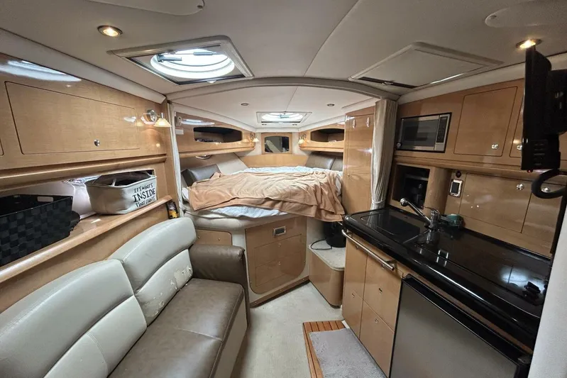  Yacht Photos Pics Luxurious 2011 Four Winns V335 yacht interior with cozy bed, kitchenette, and seating area.