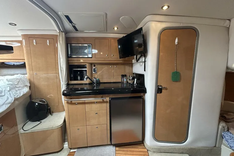  Yacht Photos Pics 2011 Four Winns V335 yacht interior with kitchenette, microwave, and TV.