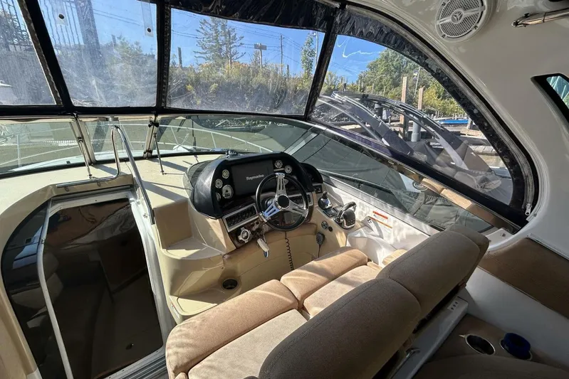  Yacht Photos Pics Interior of 2011 Four Winns V335 boat showing helm and seating area.