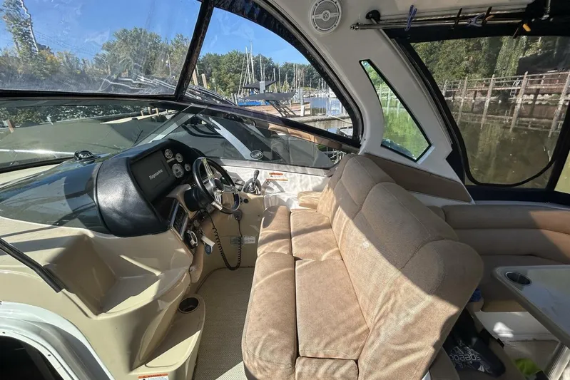  Yacht Photos Pics Interior of 2011 Four Winns V335 boat with beige seating and steering console.