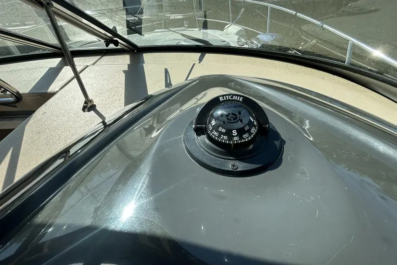  Yacht Photos Pics Compass on 2011 Four Winns V335 boat dashboard under sunlight.