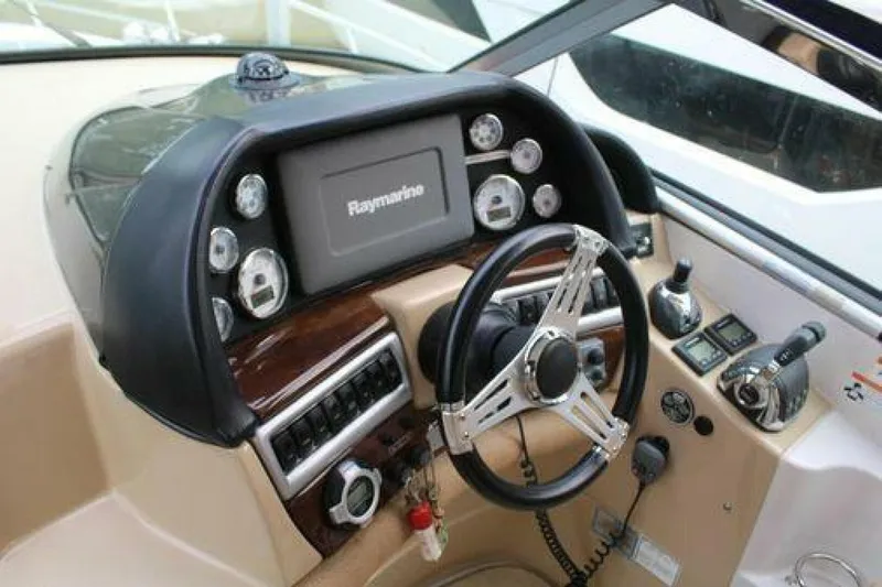  Yacht Photos Pics 2011 Four Winns V335 boat dashboard with Raymarine display and steering wheel.