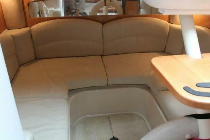  Yacht Photos Pics Interior of 2011 Four Winns V335 boat with beige seating and wooden table.